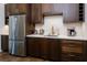 Kitchen featuring stainless steel appliances, modern countertops, and dark wood cabinetry at 7745 Radcliff St, Las Vegas, NV 89123