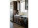 Kitchen with stainless steel appliances, dark wood cabinetry with gold handles, and white countertops at 7745 Radcliff St, Las Vegas, NV 89123