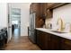 Modern kitchen features stainless steel appliances, dark wood cabinetry, and white subway tile backsplash at 7745 Radcliff St, Las Vegas, NV 89123