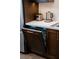 Kitchen showcases modern dishwasher with custom wood paneling to match the dark wood cabinetry at 7745 Radcliff St, Las Vegas, NV 89123
