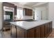 Spacious kitchen featuring a large center island with cooktop, custom cabinets, and stainless steel fridge, blending style and function at 7745 Radcliff St, Las Vegas, NV 89123