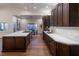 Modern kitchen with dark wood cabinetry, a large island, and stainless steel appliances at 7745 Radcliff St, Las Vegas, NV 89123