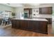 Spacious kitchen featuring custom wood cabinets, modern stainless steel appliances, and a large center island with a cooktop at 7745 Radcliff St, Las Vegas, NV 89123