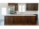 A kitchen with dark wood cabinets, white counter tops and stainless steel appliances at 7745 Radcliff St, Las Vegas, NV 89123