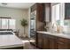 Modern kitchen featuring custom cabinets, stainless steel refrigerator and a view to the dining area, flooded with natural light at 7745 Radcliff St, Las Vegas, NV 89123