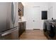 Laundry room featuring dark wood cabinetry and stainless steel appliances and a modern washer and dryer at 7745 Radcliff St, Las Vegas, NV 89123