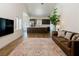 Open concept living room and kitchen with dark wood cabinets and stainless steel appliances at 7745 Radcliff St, Las Vegas, NV 89123