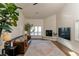 Bright living room with a fireplace, dark leather couch and stylish area rug at 7745 Radcliff St, Las Vegas, NV 89123