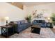 Living room featuring sofas, decorative coffee table, patterned rug, and bright light at 7745 Radcliff St, Las Vegas, NV 89123