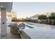 Outdoor kitchen area featuring granite countertops and views of the pool and backyard at 7745 Radcliff St, Las Vegas, NV 89123