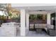The outdoor living area has a ceiling fan, kitchen, bar and comfortable conversation area at 7745 Radcliff St, Las Vegas, NV 89123