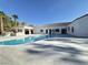Luxurious backyard features a sparkling pool, covered patio, and ample lounging space, perfect for outdoor entertaining at 7745 Radcliff St, Las Vegas, NV 89123
