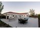 Inviting poolside patio with an outdoor kitchen, fire pit, and ample seating at 7745 Radcliff St, Las Vegas, NV 89123