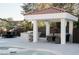 Relaxing poolside patio with covered outdoor kitchen, bar, and comfortable seating at 7745 Radcliff St, Las Vegas, NV 89123