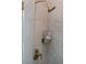 Shower stall with bronze shower head and controls is tiled in a neutral color and features recessed soap dispensers at 7745 Radcliff St, Las Vegas, NV 89123