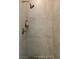 Shower stall with bronze shower head and pebbled floor is tiled in a neutral color at 7745 Radcliff St, Las Vegas, NV 89123