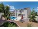 Backyard offers a pool with a diving board, trees for shade, a paved patio and beautiful landscaping at 8113 Blue Cascade Ave, Las Vegas, NV 89128