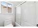 Cozy bathroom featuring a combination shower and tub, toilet, and a bright window providing natural light at 8113 Blue Cascade Ave, Las Vegas, NV 89128