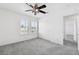 Bright bedroom featuring soft carpeting, a ceiling fan, and a bright window with plantation shutters at 8113 Blue Cascade Ave, Las Vegas, NV 89128