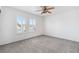 Spacious bedroom featuring soft carpeting, a ceiling fan, and large windows offering plenty of natural light at 8113 Blue Cascade Ave, Las Vegas, NV 89128
