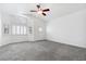 Bright bedroom with neutral carpet, ceiling fan, and natural light at 8113 Blue Cascade Ave, Las Vegas, NV 89128