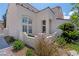 Front entrance features white columns, arched entryway, decorative plants and an manicured lawn at 8113 Blue Cascade Ave, Las Vegas, NV 89128