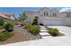 Beautiful home featuring well-maintained landscaping, concrete walkway, and a two-car garage at 8113 Blue Cascade Ave, Las Vegas, NV 89128