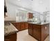 Open kitchen has an island, granite counters, lots of light, and tile backsplash at 8113 Blue Cascade Ave, Las Vegas, NV 89128