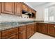 Kitchen features wood cabinets, granite counters, decorative backsplash and range at 8113 Blue Cascade Ave, Las Vegas, NV 89128