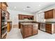 Bright kitchen features an island, granite counters, and modern stainless appliances at 8113 Blue Cascade Ave, Las Vegas, NV 89128