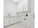 Functional laundry room with white cabinets and sink at 8113 Blue Cascade Ave, Las Vegas, NV 89128