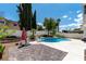 Relaxing pool with a diving board, lounge chairs and a paved patio in the landscaped backyard at 8113 Blue Cascade Ave, Las Vegas, NV 89128