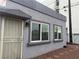 Gray stucco exterior features a secure metal door and windows allowing natural light at 817 Stewart Ave, Las Vegas, NV 89101