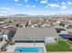 The aerial view showcases a home with covered patio, pool, and sports court nestled in a well-planned community at 8840 Harvest Sunset St, Las Vegas, NV 89113