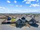 An aerial view of the home with a basketball court, putting green, gray exterior, and mountain views at 8840 Harvest Sunset St, Las Vegas, NV 89113