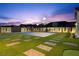 Spacious backyard featuring a private basketball court and lush green landscaping at 8840 Harvest Sunset St, Las Vegas, NV 89113