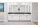 Elegant bathroom vanity with dual sinks, sleek black countertop, and ample storage space at 8840 Harvest Sunset St, Las Vegas, NV 89113