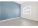 Serene bedroom with light wood floors and a large window allowing natural light at 8840 Harvest Sunset St, Las Vegas, NV 89113