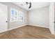 Bedroom with wood floors, ceiling fan, and bright windows at 8840 Harvest Sunset St, Las Vegas, NV 89113