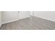 Neutral bedroom with wood-look floors, white trim, and closet with doors at 8840 Harvest Sunset St, Las Vegas, NV 89113