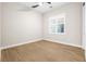 Empty bedroom with wood flooring, ceiling fan, and white trim at 8840 Harvest Sunset St, Las Vegas, NV 89113
