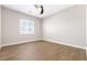 Bright bedroom with wood-look tile flooring and a ceiling fan at 8840 Harvest Sunset St, Las Vegas, NV 89113