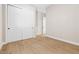 This room has wood-look tile flooring and white bi-fold doors for ample closet space at 8840 Harvest Sunset St, Las Vegas, NV 89113