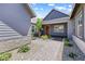 Charming front porch with a walkway lined with beautiful stone and desert landscaping leading to a red front door at 8840 Harvest Sunset St, Las Vegas, NV 89113