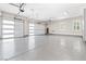 A spacious three-car garage with epoxy flooring and bright overhead lighting at 8840 Harvest Sunset St, Las Vegas, NV 89113
