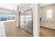 Kitchen with stainless steel fridge, and an adjacent dining area overlooking the pool and backyard at 8840 Harvest Sunset St, Las Vegas, NV 89113