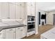 Kitchen with built in oven and microwave with great countertops with view into adjacent living room at 8840 Harvest Sunset St, Las Vegas, NV 89113