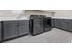 Modern laundry room with front loading washer and dryer with ample storage at 8840 Harvest Sunset St, Las Vegas, NV 89113