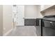 Laundry room with gray cabinets, white countertops, sink, and stainless steel appliances at 8840 Harvest Sunset St, Las Vegas, NV 89113
