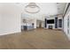 Open-concept living area with modern fireplace, tile flooring, and access to gourmet kitchen at 8840 Harvest Sunset St, Las Vegas, NV 89113